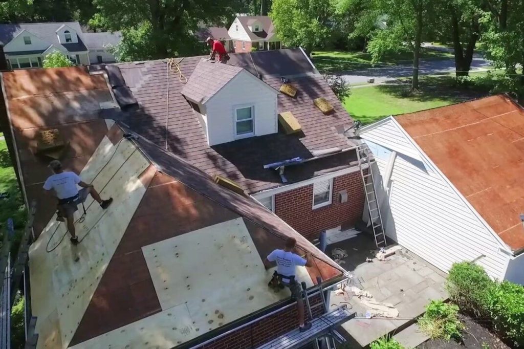 Haverford Pa red brick house with LandMark Pro Shingles being installed
