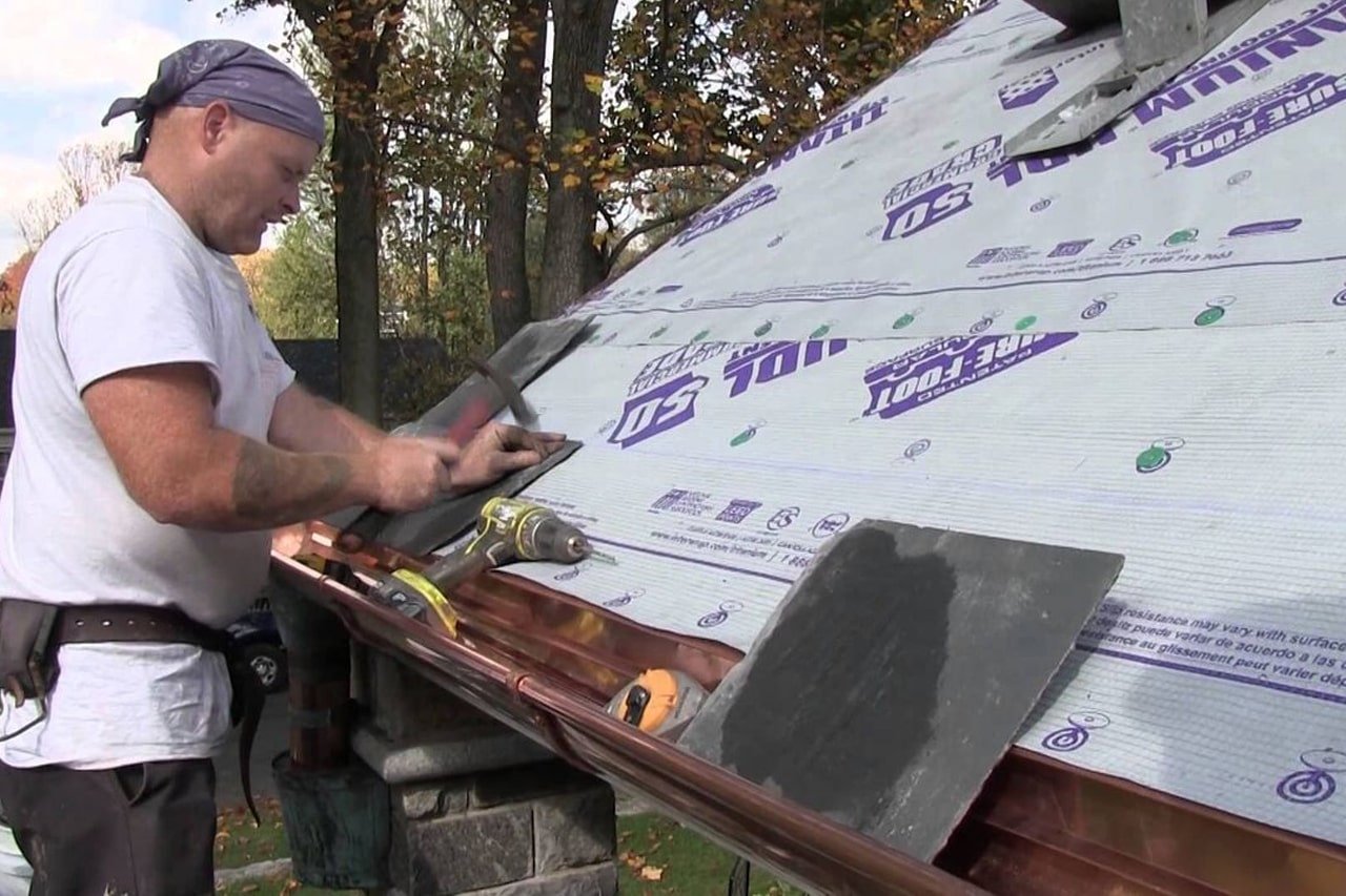 roofer repairing a storm damaged slate roof in Wyomissing Pa